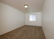 Thumbnail 15 of 28 - an empty room with carpet and a window. Fargo, ND Thunder Creek Apartments