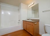 Thumbnail 11 of 28 - a bathroom with a toilet sink and bathtub. Fargo, ND Thunder Creek Apartments