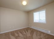 Thumbnail 9 of 28 - an empty room with carpet and a window. Fargo, ND Thunder Creek Apartments