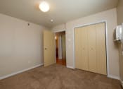 Thumbnail 10 of 28 - a bedroom with a closet and a door to the bathroom. Fargo, ND Thunder Creek Apartments