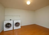 Thumbnail 12 of 28 - a laundry room with two washers and a dryer. Fargo, ND Thunder Creek Apartments