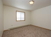 Thumbnail 15 of 16 - an empty living room with carpet and a window
