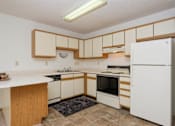 Thumbnail 7 of 16 - a kitchen with black and white appliances. Fargo, ND Twin Parks Apartments.