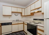 Thumbnail 8 of 16 - a kitchen with black and white appliances. Fargo, ND Twin Parks Apartments.