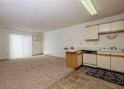Thumbnail 6 of 16 - a living room with a glass sliding door. Fargo, ND Twin Parks Apartments.