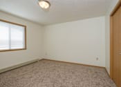Thumbnail 13 of 16 - a bedroom with a window. Fargo, ND Twin Parks Apartments.