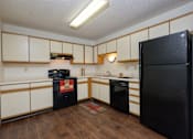 Thumbnail 12 of 16 - a kitchen with black and white appliances. Fargo, ND Twin Parks Apartments.