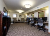 Thumbnail 21 of 21 - a library with computers and chairs. Fargo, ND Crossroads Apartments