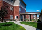 Thumbnail 45 of 45 - a sidewalk leading to a building with a covered walkway