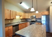 Thumbnail 21 of 45 - a kitchen with stainless steel appliances and granite counter tops. Fargo, ND Urban Plains Apartments