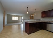 Thumbnail 14 of 45 - an empty kitchen and living room with wood flooring. Fargo, ND Urban Plains Apartments