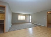 Thumbnail 13 of 45 - an empty living room with wood floors and a window. Fargo, ND Urban Plains Apartments