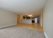 Thumbnail 15 of 45 - an empty living room and kitchen with a hard wood floor. Fargo, ND Urban Plains Apartments