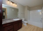 Thumbnail 19 of 45 - a bathroom with a sink and a toilet and a shower. Fargo, ND Urban Plains Apartments