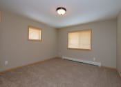 Thumbnail 17 of 45 - a bedroom with two windows and a carpet. Fargo, ND Urban Plains Apartments