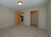 Thumbnail 18 of 45 - a bedroom with a door to a bedroom and a closet. Fargo, ND Urban Plains Apartments
