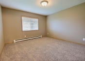 Thumbnail 23 of 45 - a bedroom with carpet and a window. Fargo, ND Urban Plains Apartments