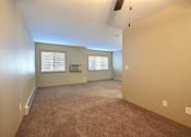 Thumbnail 39 of 45 - an empty living room with carpet and a window. Fargo, ND Urban Plains Apartments