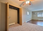 Thumbnail 35 of 45 - an empty room with a closet and a ceiling fan. Fargo, ND Urban Plains Apartments