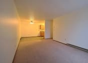 Thumbnail 8 of 26 - the living room and dining room of an empty apartment with white walls and carpet. Fargo, ND Village West Apartments