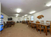 Thumbnail 25 of 25 - a community room with multiple tables and chairs. Fargo, ND North Sky Apartments