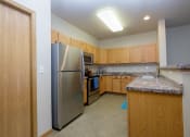 Thumbnail 27 of 61 - A large kitchen with stainless steel appliances and granite counter tops. West Fargo, ND West Lake Apartments
