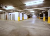 Thumbnail 57 of 61 - A large empty parking garage with yellow pillars and white walls. West Fargo, ND West Lake Apartments.