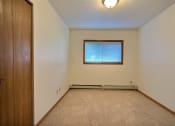 Thumbnail 7 of 11 - a bedroom with a window and a door. Fargo, ND Westcourt Apartments