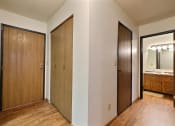 Thumbnail 9 of 11 - the entryway to a bedroom with two closets and a bathroom with a mirror. Fargo, ND Westcourt Apartments