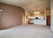 Thumbnail 22 of 61 - A living room with a kitchen in the background. West Fargo, ND West Lake Apartments.