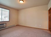 Thumbnail 24 of 61 - A bedroom with carpet and a window. West Fargo, ND West Lake Apartments.