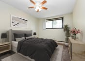 Thumbnail 3 of 11 - White Bear Lake, MN White Bear Terrace Apartments. a bedroom with a large bed and a ceiling fan