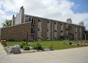 Thumbnail 1 of 9 - An exterior of a brick apartments building. Windgate Apartments | Fargo, ND