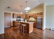 Thumbnail 17 of 21 - a kitchen with stainless steel appliances and wooden cabinets.Fargo, ND Wolf Creek Apartments