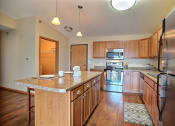 Thumbnail 16 of 21 - a kitchen with stainless steel appliances and wooden cabinets. Fargo, ND Wolf Creek Apartments