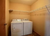Thumbnail 21 of 21 - a laundry room with a washer and dryer. Fargo, ND Wolf Creek Apartments