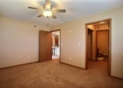 Thumbnail 14 of 21 - a bedroom with a closet and a door to a bathroom. Fargo, ND Wolf Creek Apartments