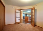 Thumbnail 10 of 21 - a bedroom with a closet and a door to a kitchen. Fargo, ND Wolf Creek Apartments