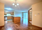 Thumbnail 8 of 21 - a kitchen and dining room with wood floors. Fargo, ND Wolf Creek Apartments