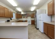 Thumbnail 19 of 23 - a kitchen with white appliances and wooden cabinets .Fargo, ND North Sky Apartments