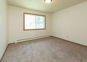 Thumbnail 13 of 34 - a bedroom with carpet and a window. Fargo, ND Islander Apartments