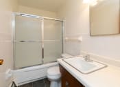 Thumbnail 15 of 34 - a bathroom with a sink toilet and shower. Fargo, ND Islander Apartments