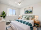 Thumbnail 9 of 23 - A bedroom with a large bed and a painting on the wall.