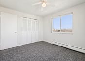 Thumbnail 10 of 23 - A room with a ceiling fan and a window overlooking a snowy landscape.