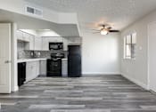 Thumbnail 6 of 23 - A kitchen with a black oven and microwave.