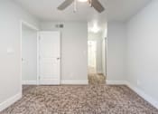 Thumbnail 14 of 36 - an empty room with carpet and a ceiling fan