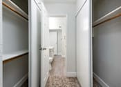 Thumbnail 13 of 36 - a bathroom with a toilet and a walk in closet