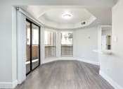Thumbnail 4 of 36 - the living room of an apartment with wood flooring and sliding glass doors