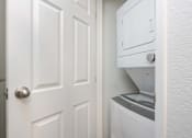 Thumbnail 16 of 36 - an open door to a laundry room with a dryer on the wall