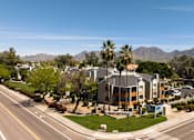 Thumbnail 20 of 36 - an aerial view of a building with palm trees and a street